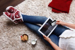 Woman shopping online with a tablet and a credit card